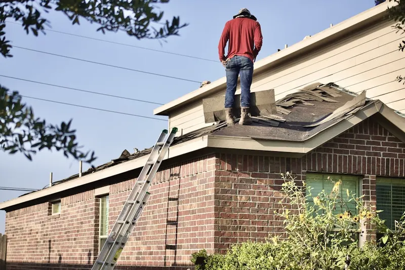Professional roofer working on a residential roof in Downtown Durham
